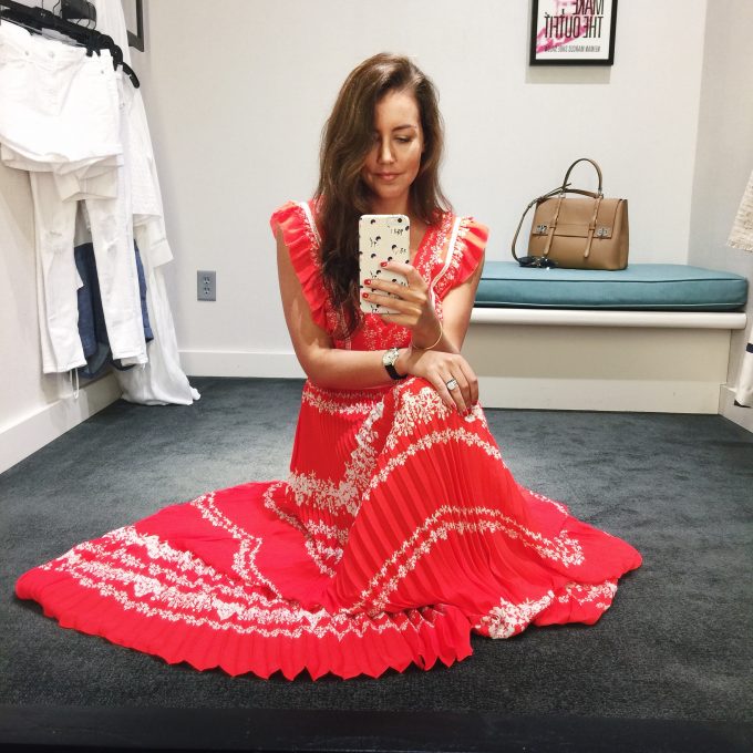 Amy havins wears the self portrait red pleated maxi dress.