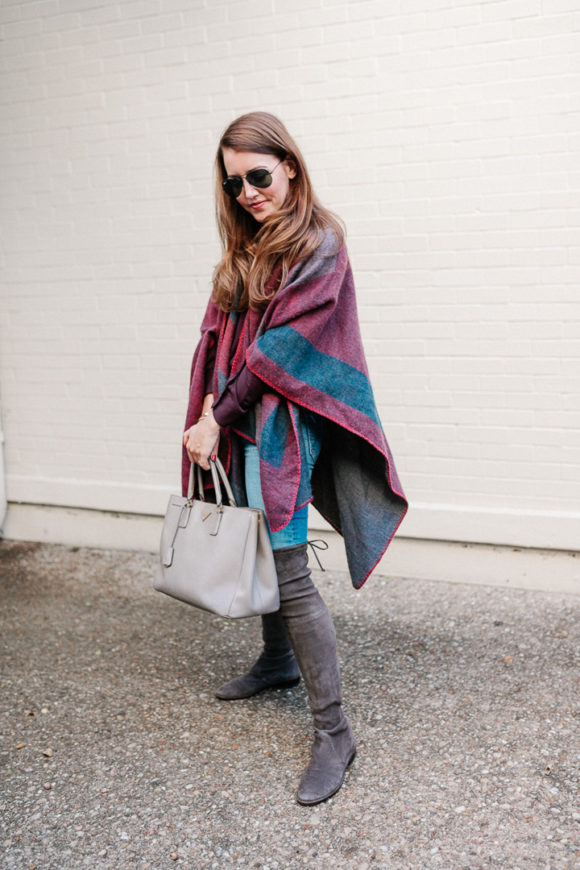 Amy Havins wears a poncho with stuart weitzman over the knee boots and ...